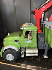 Bruder 02824 MACK Granite Timber Truck, green cabin, and a large red loading