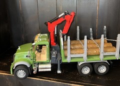 Bruder 02824 MACK Granite Timber Truck, green cabin, and a large red loading