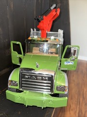 Bruder 02824 MACK Granite Timber Truck, green cabin, and a large red loading