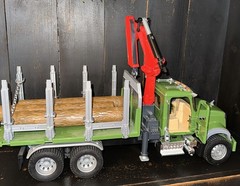 Bruder 02824 MACK Granite Timber Truck, green cabin, and a large red loading