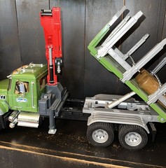 Bruder 02824 MACK Granite Timber Truck, green cabin, and a large red loading
